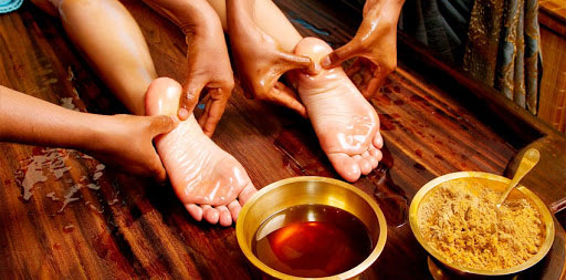 a women taking foot ayurveda massage